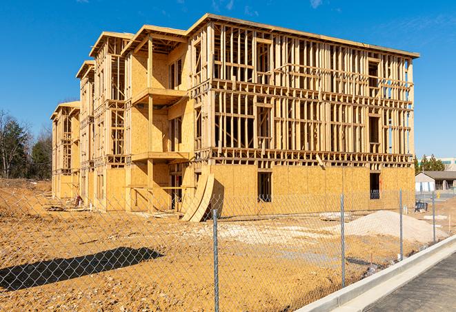 a temporary chain link fence locking away a building under renovation, serving as a security tool in Sheridan, MT